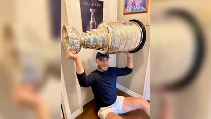 Sam Bennett poses with Stanley Cup in front of childhood poster
